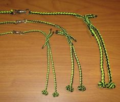 A COMPLETE FOUR STRAND ROUND BRAIDED TETHERING SYSTEM WITH SWIVEL